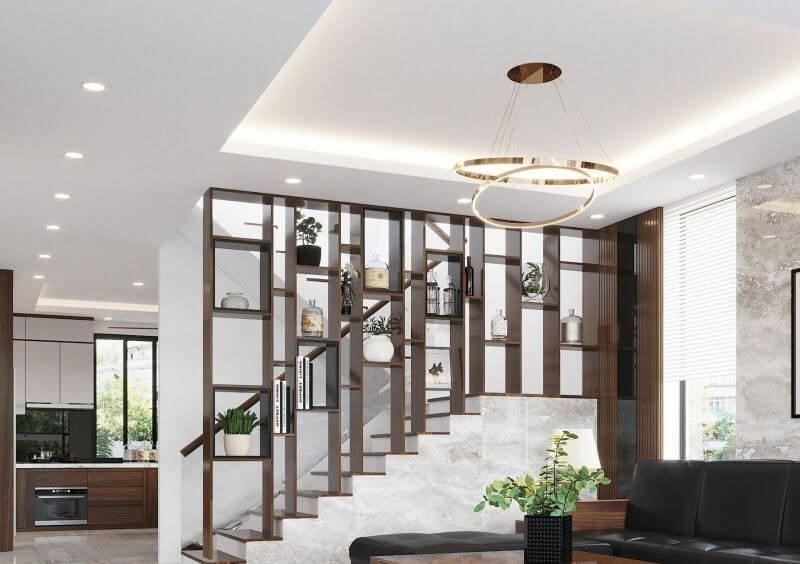 Để tiện lợi và tối ưu không gian, cầu thang được thiết kế ở giữa phòng khách và nhà bếp.